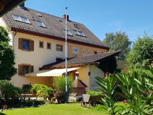 une grande maison jaune avec un toit dans l'établissement Ferienwohnungen Kumpf, à Bad Aibling