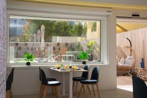 a room with a window with a table and chairs at Casual Raízes Porto in Porto