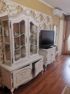 a white hutch with a television and a tv at Luxury apartment Amalfi 300 m from the beach in Varna City