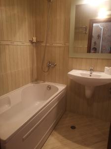 a bathroom with a bath tub and a sink at Luxury apartment Amalfi 300 m from the beach in Varna City