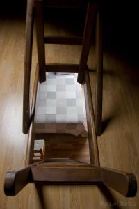 a wooden chair sitting on top of a wooden floor at Hotel Saueth in Tredós