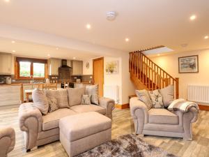 a living room with two couches and a kitchen at Little Lodge in Kings Lynn