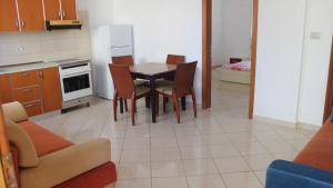 Una cocina con una mesa y sillas en una habitación. en Bledi's Comfy Apartment in New Blvd / Free Parking, en Tirana 2 fotos más