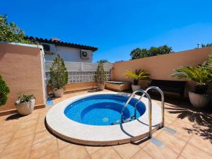 a swimming pool in a yard with a patio at MAS NOU 2 in Castelló d'Empúries