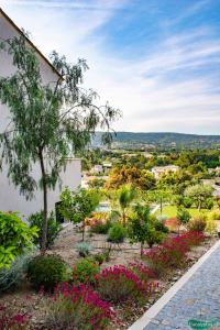 a view of a garden with pink flowers at Le Clos des Eucalyptus in Plan-de-la-Tour