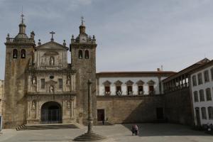 an old building with a clock tower and a church at Torre Medieval in Viseu
