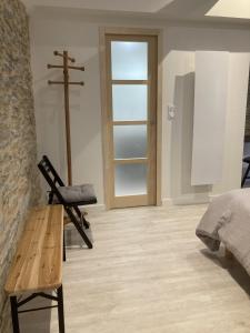 a bedroom with a cross and a wooden bench and a crucifix at La Maison du Cocher - Chambre indépendante climatisée en Hypercentre - Lit Queen Size in Angers