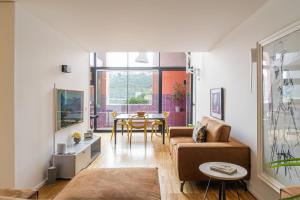 a living room with a couch and a table at Porto Insight Apartment River View - Pool & Garage in Porto