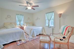 a bedroom with two beds and a chair with a dog sitting in a chair at Spacious and Modern Ashley Falls Home on 1 Acre 