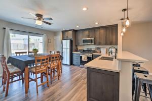 a kitchen and dining room with a table and chairs at Pet-Friendly Bullhead City Abode with Game Room in Bullhead City