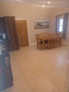 a kitchen and dining room with a table and chairs at No 9 Seanachaí Holiday Homes Holiday home in Dungarvan