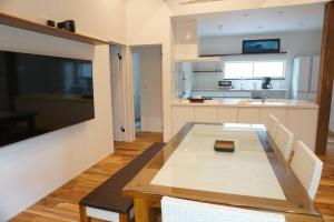 a kitchen with a table and chairs in a room at Doublerainbow Resort Katsuura in Katsuura