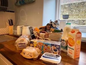 a kitchen counter with a bunch of food on it at Baker's Cottage in Castle Combe