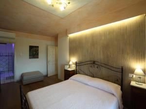 a bedroom with a bed and two lights on the ceiling at B&b La Fontana Borbone in Lauria