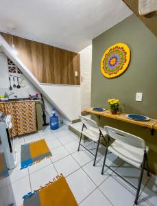 a kitchen with a table and chairs in a room at Tiny House in Pipa