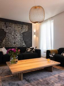 a living room with a couch and a coffee table at Le Siam in Brest