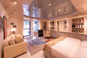 a bedroom with a large bed and a living room at Die Villa Mettmann in Mettmann