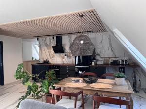 a kitchen and dining room with a table and chairs at Cozy beach house Jurmala III in Jūrmala