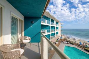 a balcony with a view of the beach and the ocean at Beach Terrace in Carlsbad