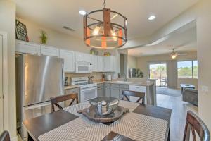 a kitchen with a table and chairs and a chandelier at Welcoming Surprise Home with Patio and Spacious Yard in Surprise