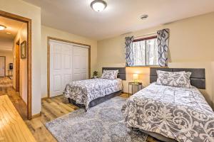 a bedroom with two beds and a window at Mosinee Escape with Fire Pit - 1 Mi to River! in Mosinee