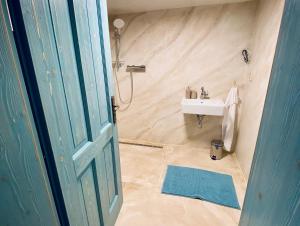 a bathroom with a sink and a white sink at Penzion - Vinařství Hanuš in Blučina