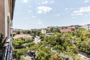 a view of a city from the balcony of a building at Corvinus Smart Apartment with Beautiful View in Budapest