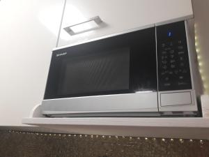 a microwave oven sitting on top of a counter at HOLIDAY HOME NORA**** Loznati Cres in Loznati