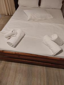 a bed with two towels and two pillows on it at CORFU OASIS studio in Neochorákion