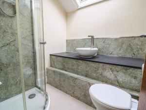 a bathroom with a shower and a toilet and a sink at The Dukes Apartments, Flat 3 in Scarborough