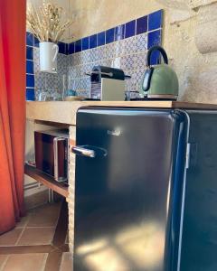 a blue refrigerator in a kitchen with a counter at Chambre Loulou • Maison Colombage in Provins
