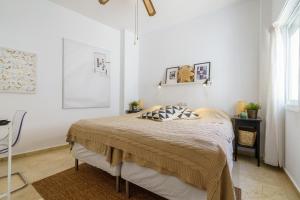 um quarto com uma cama num quarto branco em Penthouse Victoria em Fuengirola