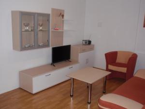 a room with a desk with a tv and a chair at Apartmán Janoušek in Humpolec