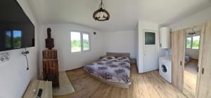 a bedroom with a bed in the corner of a room at Mountain View 2 - ciubar in Câmpulung