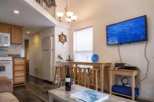 cocina y sala de estar con mesa y TV en la pared en H - San Juan, en Fort Bragg