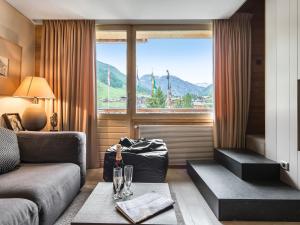 a living room with a couch and a window at Appartement Val-d'Isère, 2 pièces, 4 personnes - FR-1-567-56 in Val dʼIsère