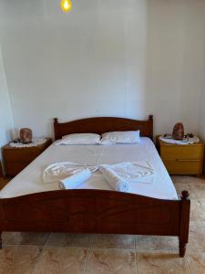 a bed with two towels on top of it at Emilios Traditional Villa in Dhërmi