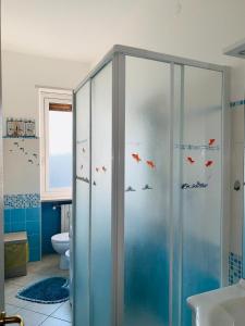 a bathroom with a shower with fish stickers on it at Casa Viola in Diano Marina