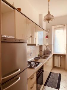 a kitchen with a stainless steel refrigerator and a stove at Casa Viola in Diano Marina
