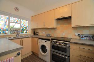 a kitchen with a washer and a dishwasher at Exmouth - Newly available, near the Beach in Exmouth