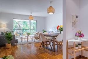 a dining room and living room with a table and chairs at Lovely apartment at the best location in Funchal in Funchal