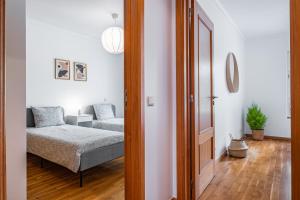 a living room with a bed and a couch at Lovely apartment at the best location in Funchal in Funchal