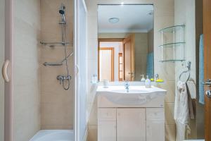a bathroom with a sink and a shower at Lovely apartment at the best location in Funchal in Funchal