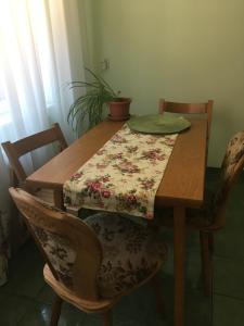 a wooden table with a table cloth on it with two chairs at Casa Bis in Sibiu