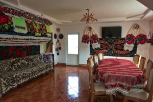 a dining room with a table and chairs with a red table cloth at Breb Casa Luca in Breb