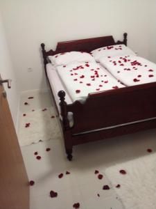 a bed with roses on the floor in a bedroom at COUNTRY HOUSE in Bihać