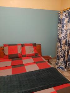 a bedroom with a bed with a colorful blanket at La Brise in Étang-Salé les Bains