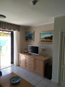 a living room with a television on a wooden cabinet at For your best holiday in Rocas del Mar with amazing ocean view in Costa Del Silencio