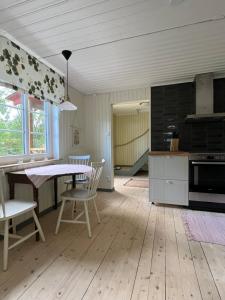 a kitchen with a table and chairs in a room at Charlottenborg in Söderköping