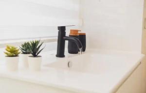 a kitchen counter with a sink with a faucet at La Guta Studio Suite Jerusalem in Jerusalem